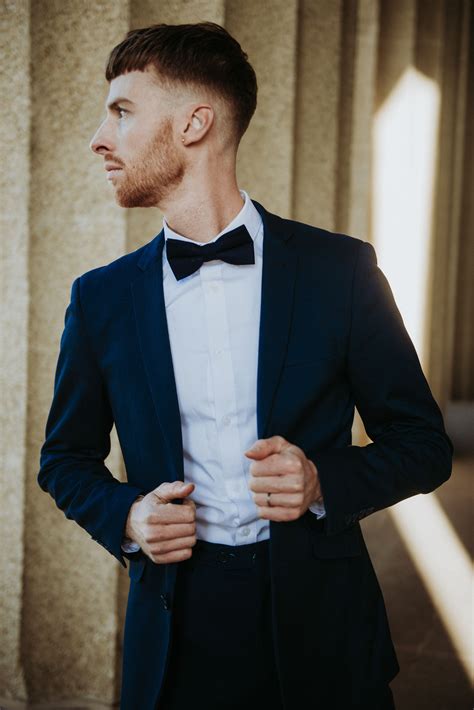 navy suit with black bow tie
